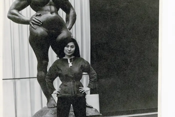 Yoko Ono with Standing Woman (1932) by Gaston Lachaise, The Museum of Modern Art Sculpture Garden, New York. c. 1960–61. (Photograph by Minoru Niizuma, Courtesy Lenono Photo Archive)